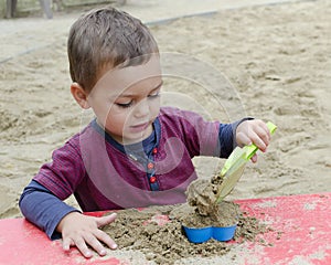 Child playing in sandpit photo