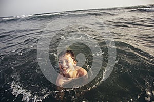 Child playing in the sea. Kid having fun outdoors. Summer vacation and healthy lifestyle concept. Selective focus