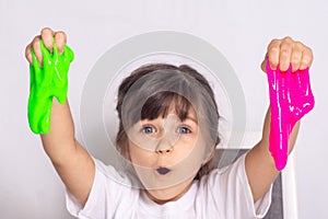 Child playing with slime. Kids squeeze and stretching slime.