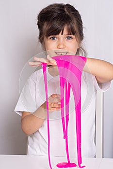 Child playing with slime. Kids squeeze and stretching slime.