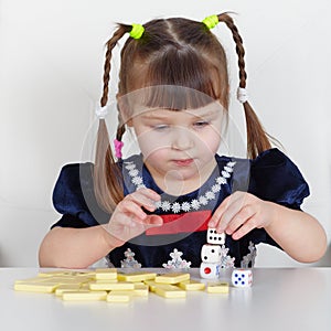 Child playing with small toys at table