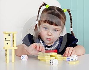 Child playing with small toys at table