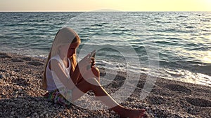 Child Playing Smartphone, Kid on Beach at Sunset, Girl Using Tablet on Seashore