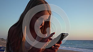 Child Playing Smartphone, Kid on Beach at Sunset, Girl Using Tablet on Seashore