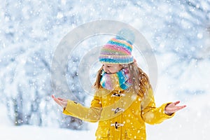 Child playing in snow on Christmas. Kids in winter