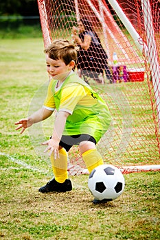 Child playing soccer goalie