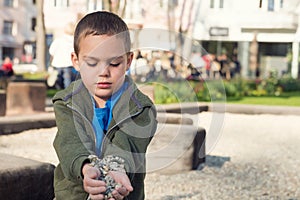 Child playing with stones in park