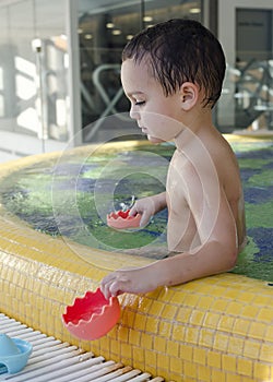 Child playing in swimming pool