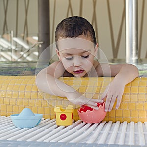 Child playing in swimming pool