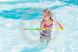 Child playing in swimming pool