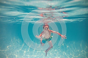 Child playing in swimming pool. Kids holidays and vacation concept. Summer kid play in swimming pool. Little child boy