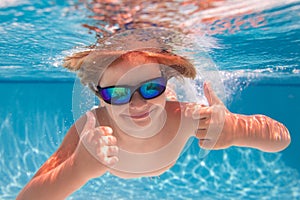 Child playing in swimming pool. Kids holidays and vacation concept. Summer kid play in swimming pool. Little child boy