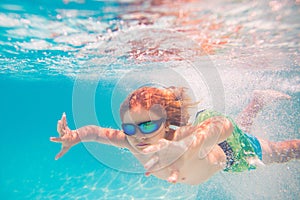 Child playing in swimming pool. Kids holidays and vacation concept. Summer kid play in swimming pool. Little child boy