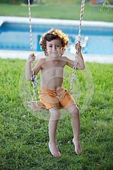 Child playing in a swing