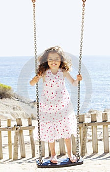 Child playing swing on vacation