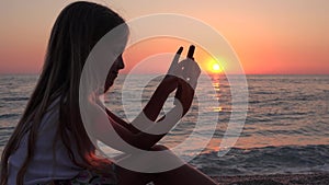 Child Playing Tablet on Beach at Sunset, Kid Using Smartphone, Girl on Seashore