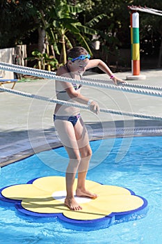 Child playing in tarzan pool