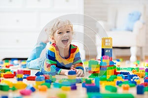 Child playing with toy blocks. Toys for kids.