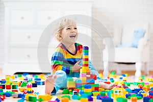 Child playing with toy blocks. Toys for kids