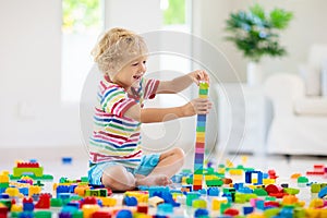 Child playing with toy blocks. Toys for kids