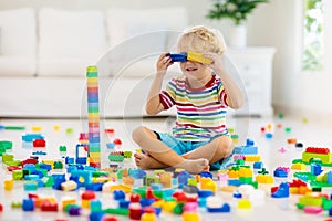 Child playing with toy blocks. Toys for kids