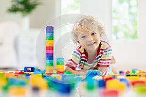 Child playing with toy blocks. Toys for kids