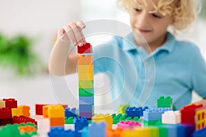 Child playing with toy blocks. Toys for kids