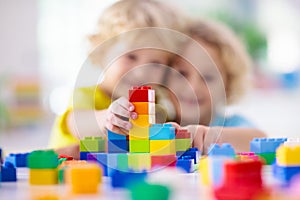 Child playing with toy blocks. Toys for kids