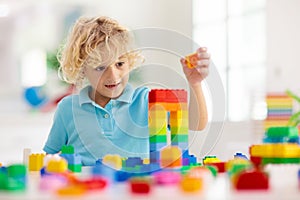 Child playing with toy blocks. Toys for kids