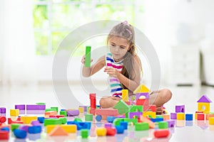 Child playing with toy blocks. Toys for kids