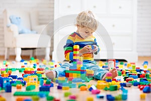 Child playing with toy blocks. Toys for kids