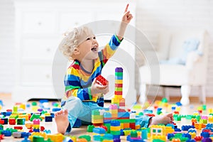 Child playing with toy blocks. Toys for kids