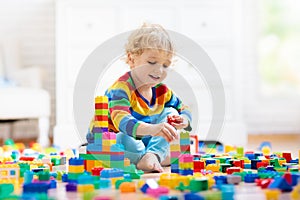 Child playing with toy blocks. Toys for kids