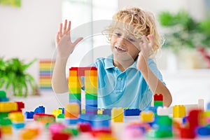 Child playing with toy blocks. Toys for kids