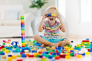 Child playing with toy blocks. Toys for kids