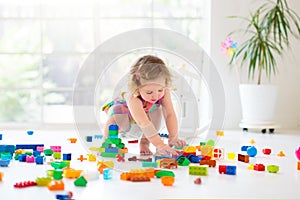 Child playing with toy blocks. Toys for kids