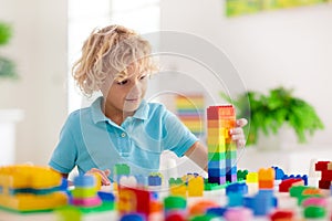 Child playing with toy blocks. Toys for kids