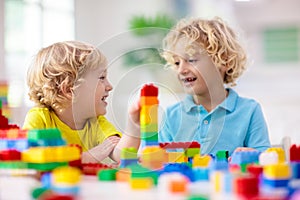 Child playing with toy blocks. Toys for kids