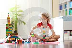 Child playing with toy blocks. Toys for kids