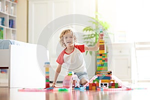 Child playing with toy blocks. Toys for kids