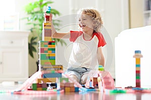 Child playing with toy blocks. Toys for kids