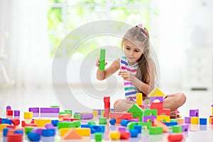 Child playing with toy blocks. Toys for kids