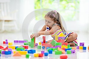 Child playing with toy blocks. Toys for kids