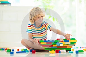 Child playing with toy blocks. Toys for kids