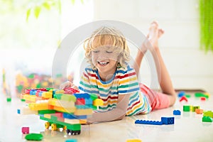 Child playing with toy blocks. Toys for kids