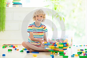 Child playing with toy blocks. Toys for kids