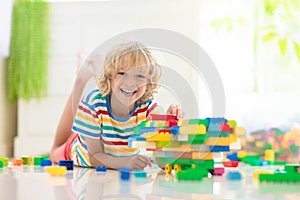 Child playing with toy blocks. Toys for kids