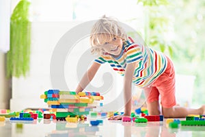 Child playing with toy blocks. Toys for kids
