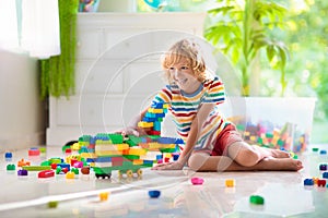 Child playing with toy blocks. Toys for kids