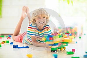 Child playing with toy blocks. Toys for kids